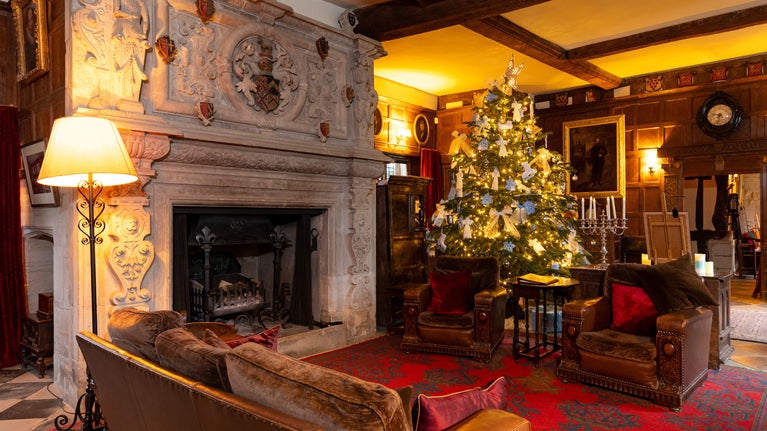 A view of the Great Hall at Baddesley Clinton, Warwickshire, with the Christmas tree in pride of place